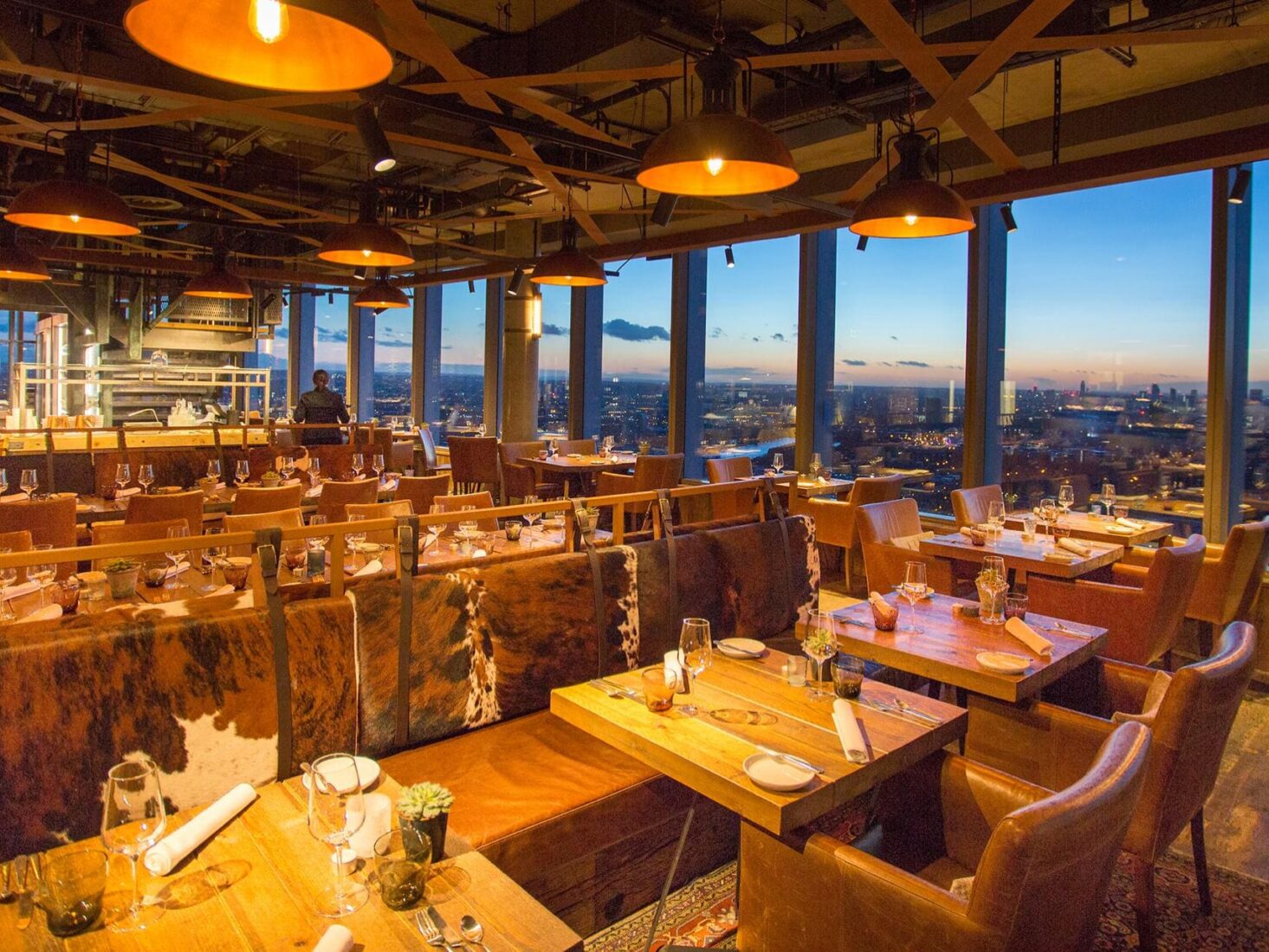 Bōkan restaurant interior overlooking the London skyline at dusk